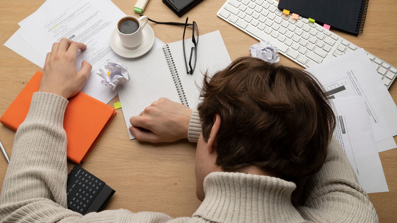 Mulher deitada na mesa com papeis espalhados