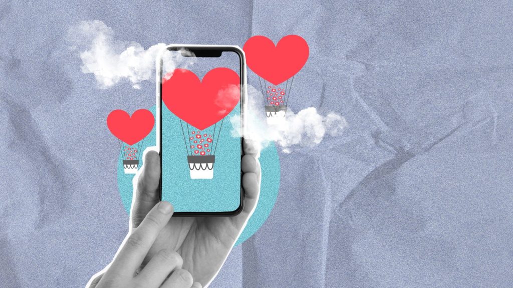Celular com bal&atilde;o de cora&ccedil;&atilde;o saindo dele em fundo cinza
