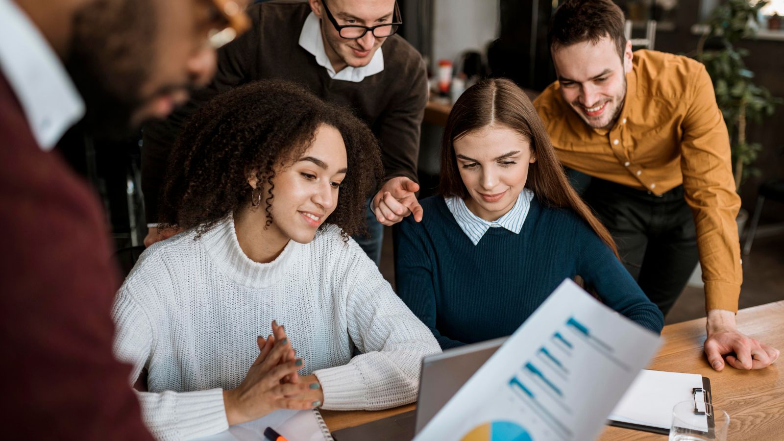 Equipe em reunião analisando gráficos