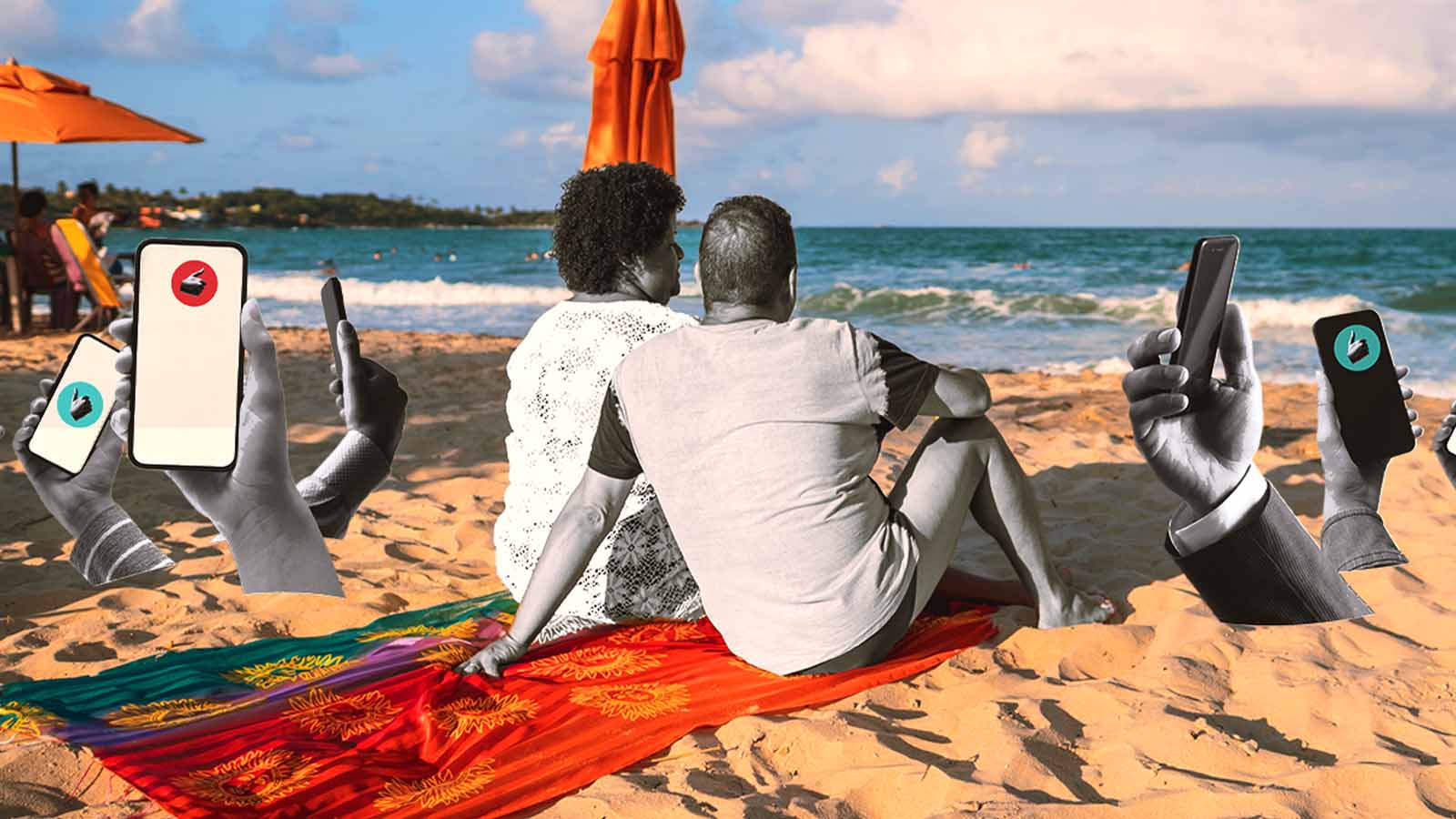 casal sentado na praia observa o mar