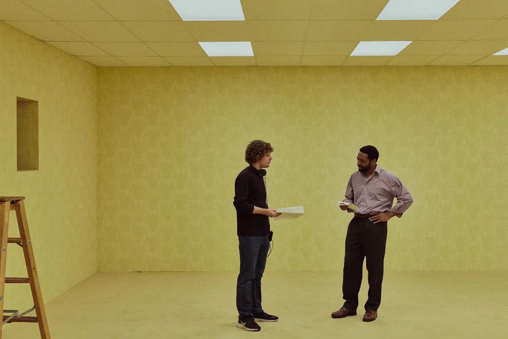 Kane Parsons conversa com o ator Chiwetel Ejiofor em um cen&aacute;rio do Backrooms durante as filmagens do novo filme da A24.