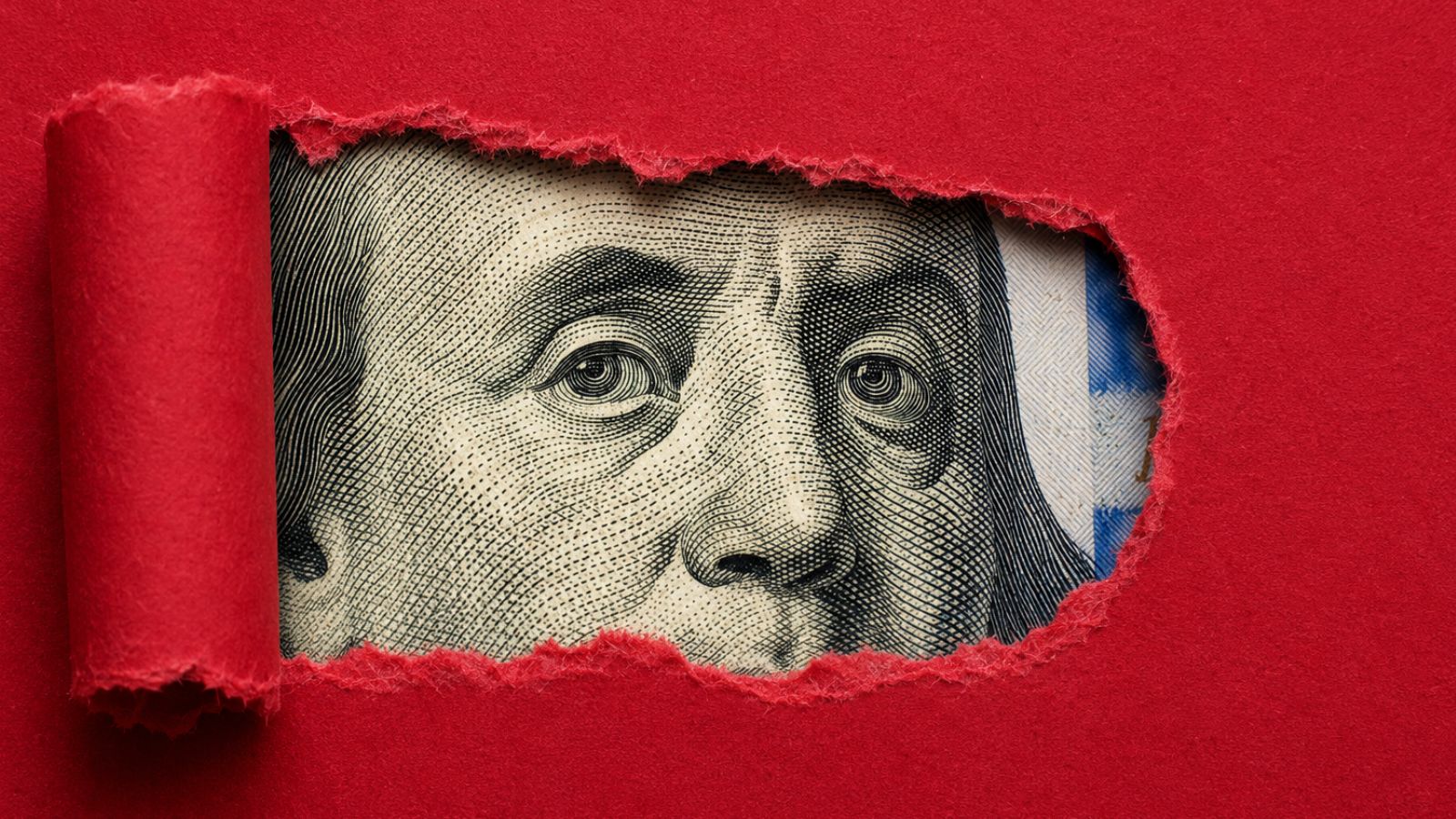 Nota de dólar escondida por um papel vermelho