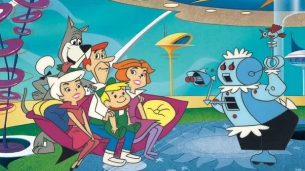 Fam&iacute;lia Jetson sentada enquanto Rosie, a rob&ocirc; dom&eacute;stica, serve uma bebida.