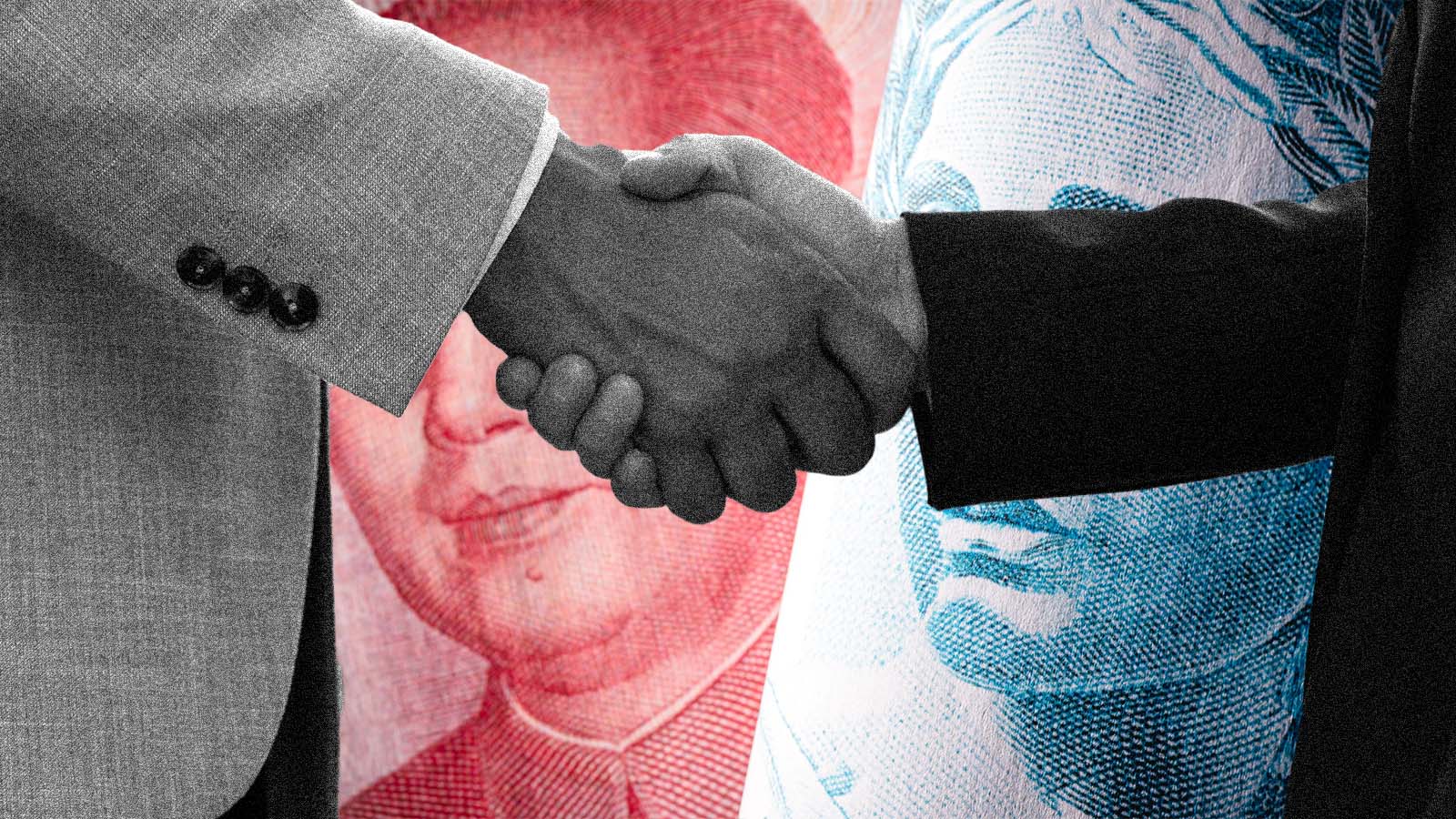 Aperto de mãos diante de cédulas chinesas representa a relação econômica entre Brasil e China.