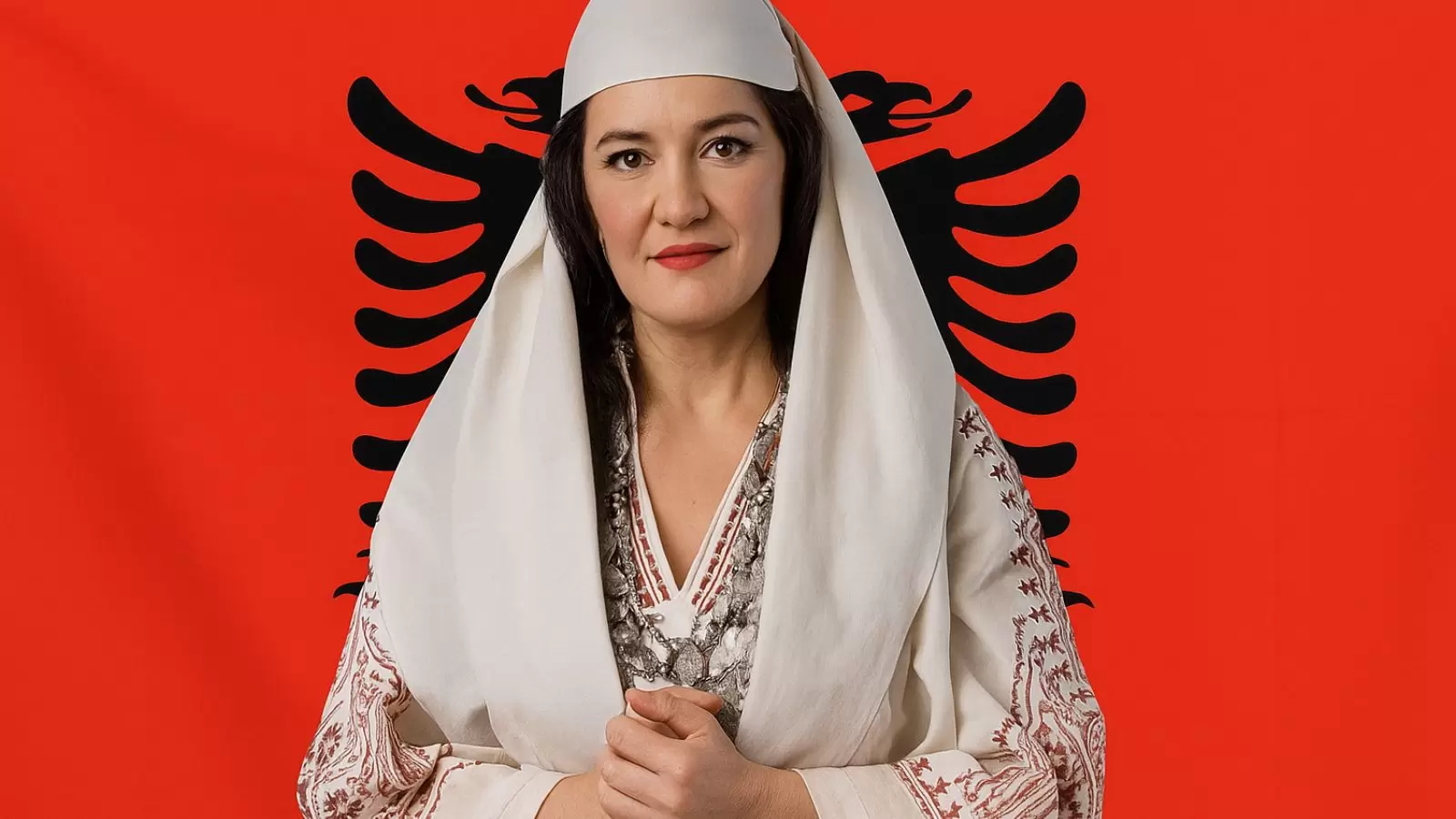 Ministra da Albânia com bandeira ao fundo