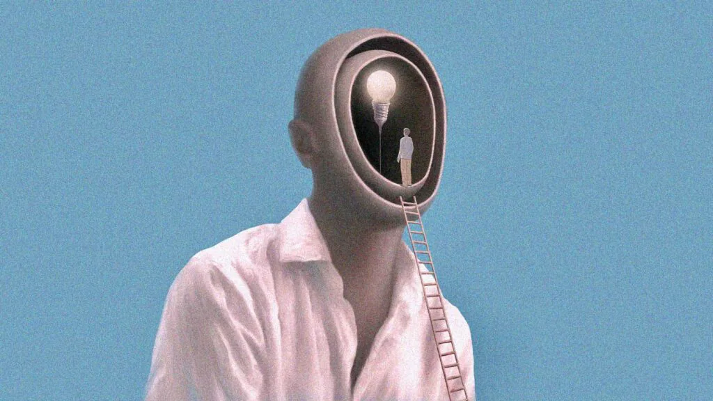 pessoa no alto da escada chega a um espaço representando o cérebro humano